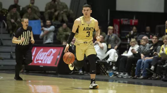 Tommy Funk dribbles up the court versus Navy