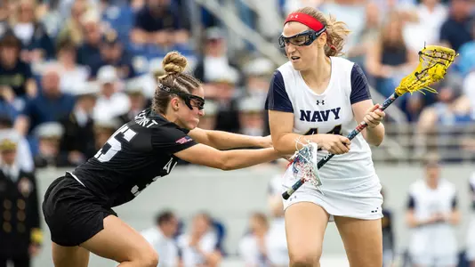 Taylor Korpela of the Army Black Knights and Nicole Victory of the Navy Midshipmen during an NCAA Division I women's lacrosse game between the Army Black Knights and Navy Midshipmen at Navy Marine Corps Memorial Stadium on April 13, 2019 in Annapolis, MD.