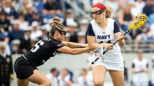 Taylor Korpela of the Army Black Knights and Nicole Victory of the Navy Midshipmen during an NCAA Division I women's lacrosse game between the Army Black Knights and Navy Midshipmen at Navy Marine Corps Memorial Stadium on April 13, 2019 in Annapolis, MD.