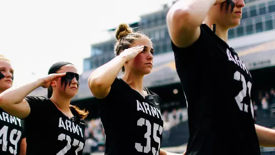 Taylor Korpela salutes during the national anthem prior to the 2019 game at Navy