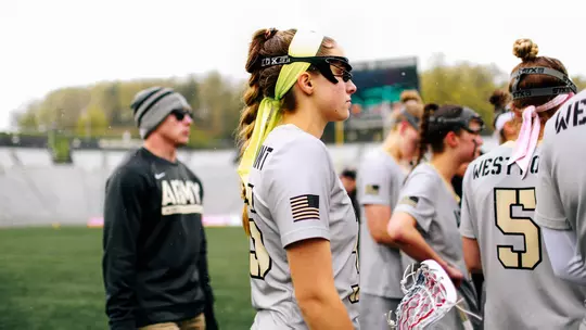 Taylor Korpela listens in on a huddle in the Patriot League Tournament game against Lehigh