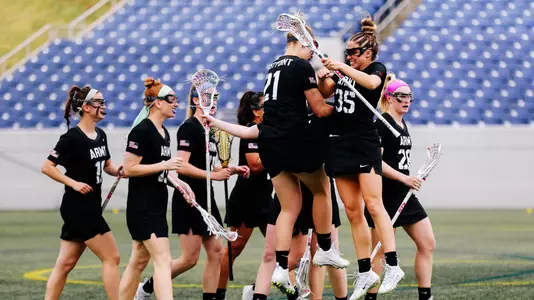 Taylor Korpela jumps with Caroline Raymond to celebrate a score at Navy in 2019