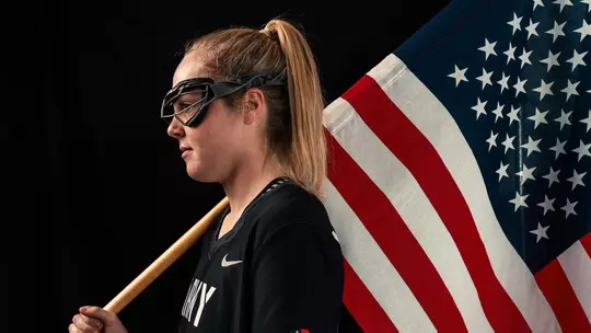 Rilee Scott holds the american flag during a photoshoot
