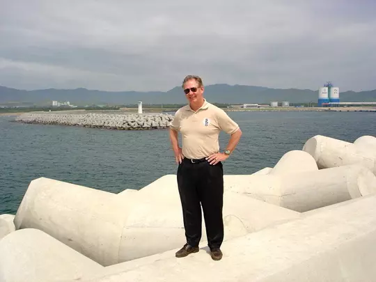 McKinney standing on banks of man-made harbor built in North Korea in 2004 to facilitate the construction of a Light Water Reactor.
