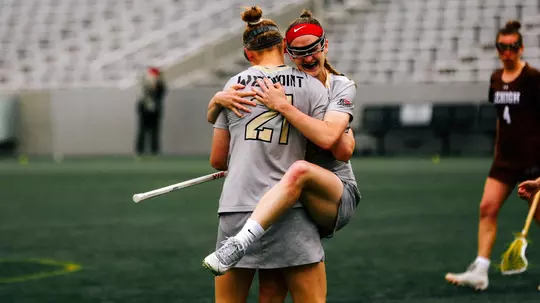 Samantha Stewart celebrates with Caroline Raymond after an Army goal