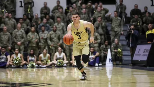 Tommy Funk brings the ball up the court against Navy