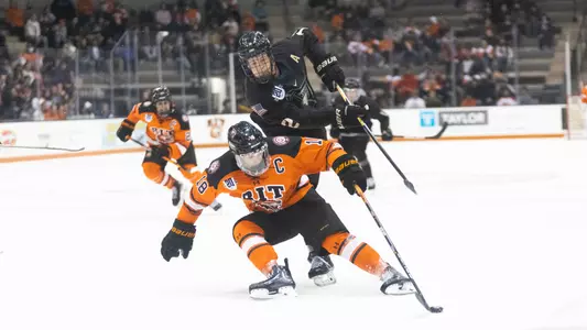 RIT's Kobe Walker, 18, tries to grab the puck on Oct. 7, 2022 at Gene Polisseni Center in Henrietta, N.Y. The RIT menâ??s hockey team is tied against Army West Point 2-2 during the second period. (Rebecca Villagracia/RIT Athletic Communications)