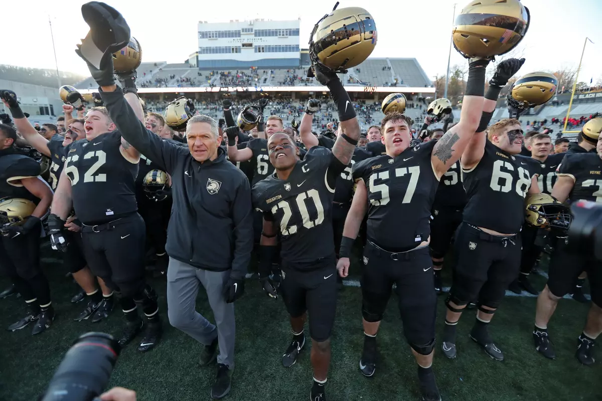 Nov 19, 2022; West Point, New York, USA; Army Black Knights head coach Jeff Monken celebrates with defensive back Marquel Broughton (20) and offensive lineman Connor Bishop (57) after a win against the Connecticut Huskies at Michie Stadium. Mandatory Credit: Danny Wild-USA TODAY Sports