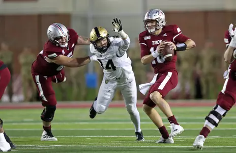 Nov 12, 2022; Troy, Alabama, USA; Troy Trojans quarterback Gunnar Watson (18) looks to evade Army Black Knights outside linebacker Andre Carter II (34) during the second half at Veterans Memorial Stadium. Mandatory Credit: Danny Wild-USA TODAY Sports