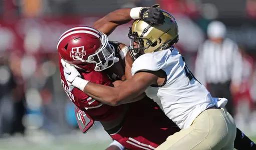 Nov 26, 2022; Amherst, Massachusetts, USA; Massachusetts Minutemen running back Ellis Merriweather (7) gets hit by Army Black Knights defensive lineman Nathaniel Smith (44) during the first half at Warren McGuirk Alumni Stadium. Mandatory Credit: Danny Wild-USA TODAY Sports
