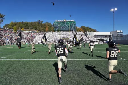 Oct 12, 2024; West Point, New York, USA; Army Black Knights tight end David Crossan (85) runs on to the field under a helicopter flyover before the first half against the UAB Blazers at Michie Stadium. Mandatory Credit: Danny Wild-Imagn Images