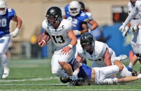 Oct 5, 2024; Tulsa, Oklahoma, USA; Army Black Knights quarterback Bryson Daily (13) breaks a tackle against the Tulsa Golden Hurricane during the second half at Skelly Field at H.A. Chapman Stadium. Mandatory Credit: Danny Wild-Imagn Images