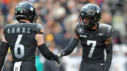 Dec 14, 2024; Landover, Maryland, USA; Army Black Knights cornerback Jaydan Mayes (7) celebrates with safety Max DiDomenico (6) during the first half of the the 125th Army-Navy game at Northwest Stadium. Mandatory Credit: Danny Wild-Imagn Images