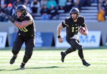 Nov 18, 2023; West Point, New York, USA; Army Black Knights quarterback Bryson Daily (13) carries the ball against the Coastal Carolina Chanticleers during the first half at Michie Stadium. Mandatory Credit: Danny Wild-USA TODAY Sports