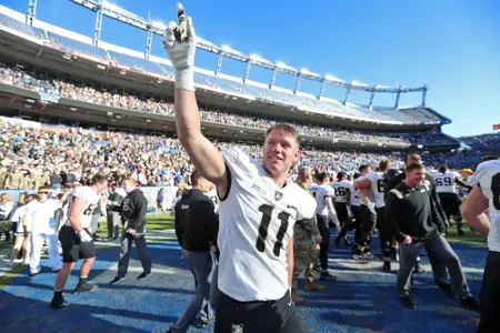 Nov 4, 2023; Denver, Colorado, USA; Army Black Knights defensive back Tommy Zitiello (11) and his teammates celebrate a 23-3 victory against the Air Force Falcons at Empower Field at Mile High. Mandatory Credit: Danny Wild-USA TODAY Sports