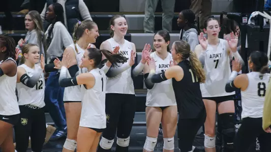 Volleyball High Fives After Sweep Over Holy Cross