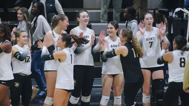 Volleyball High Fives After Sweep Over Holy Cross