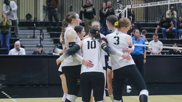 The Volleyball Team Huddles After a Point