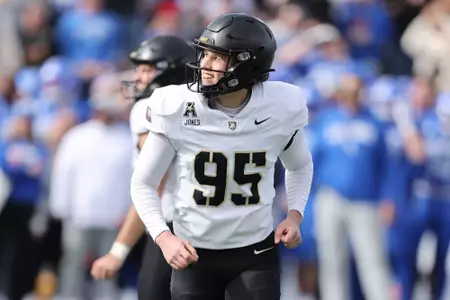 Dawson Jones runs towards the sideline smiling after kicking a good field goal against Air Force in 2025.