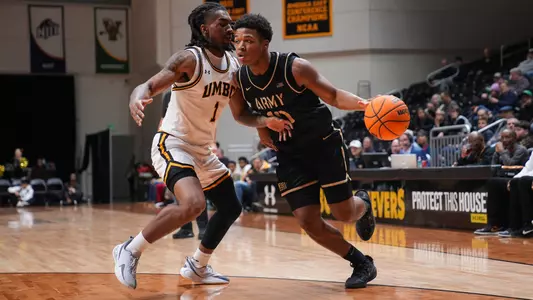 Jacen Holloway Drives the Ball Against a UMBC Defender