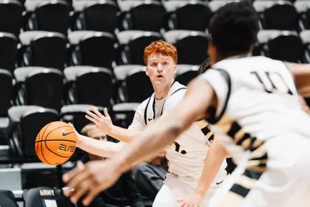 Ryan Curry Looks to Pass the Ball in the Paint Against Binghamton