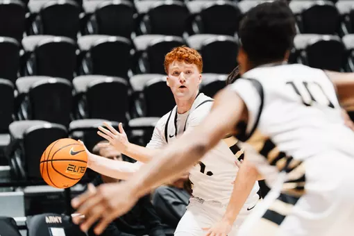 Ryan Curry Looks to Pass the Ball in the Paint Against Binghamton