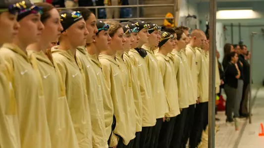 Swimming & Diving Lined Up for National Anthem at Navy