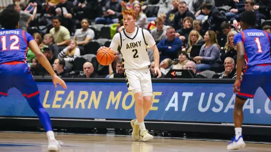 Ryan Curry Dribbling Between Two American Defenders