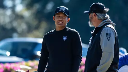 Dragon Theam talks with Head Coach Chad Bagley at the 45th Schenkel Invitational at Forest Heights CC.