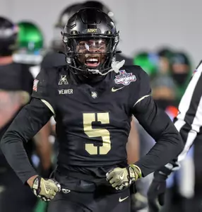 Dec 6, 2024; West Point, NY, USA; Army Black Knights cornerback Justin Weaver (5) celebrates his tackle against the Tulane Green Wave during the second half at Michie Stadium. Mandatory Credit: Danny Wild-Imagn Images