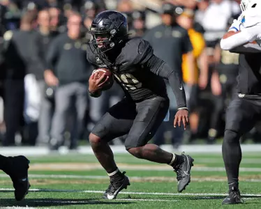 Nov 2, 2024; West Point, New York, USA; Army Black Knights quarterback Dewayne Coleman (10) looks for room to run against the Air Force Falcons during the first half at Michie Stadium. Mandatory Credit: Danny Wild-Imagn Images