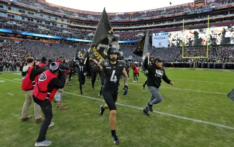 Dec 14, 2024; Landover, Maryland, USA; Army Black Knights head coach Jeff Monken and Army Black Knights wide receiver Liam Fortner (4) run on to the field holding flags before the first half of the the 125th Army-Navy game at Northwest Stadium. Mandatory Credit: Danny Wild-Imagn Images