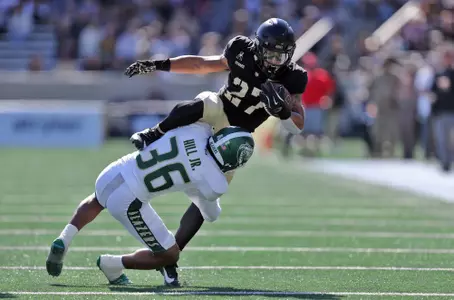 Oct 12, 2024; West Point, New York, USA; Army Black Knights running back Samari Howard (27) hurdles over UAB Blazers cornerback Kelvin Hill (36) during the first half at Michie Stadium. Mandatory Credit: Danny Wild-Imagn Images