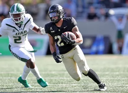 Oct 12, 2024; West Point, New York, USA; Army Black Knights running back Samari Howard (27) runs by UAB Blazers linebacker Jason Riles Jr. (27) during the second half at Michie Stadium. Mandatory Credit: Danny Wild-Imagn Images