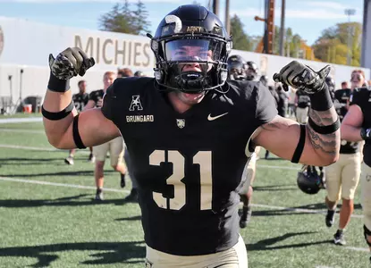 Oct 12, 2024; West Point, New York, USA; Army Black Knights linebacker Caden Brungard (31) flexes while celebrating a 44-10 win against the UAB Blazers at Michie Stadium. Mandatory Credit: Danny Wild-Imagn Images