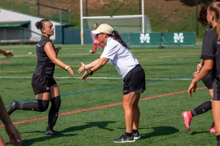 #3 Olivia Jungkunst high fives Head Coach Tracy Chao ahead of Army's 4-1 victory over Manhattan on August 17, 2025