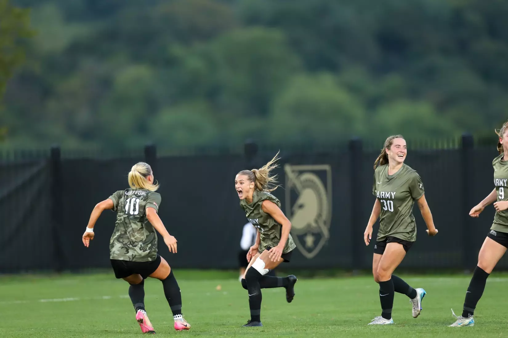 #10 Grace Pohlidal and #30 celebrate with #11 Sabrina Rogers after her goal in in Army West Point's 2-1 victory over Air Force on Aug. 21, 2025