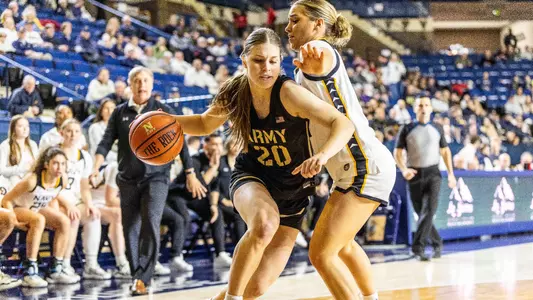 Camryn Tade drives toward the basket