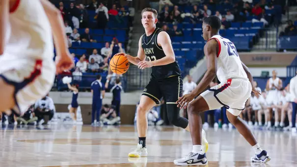 Dylan Benner Dribbles the Ball Past the Navy Defender