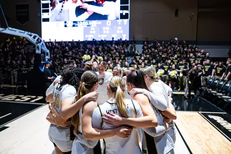 Women's basketball huddles before a game