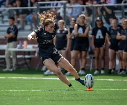 Army Women's Rugby Player Kicks Ball during match against Sacred Heart