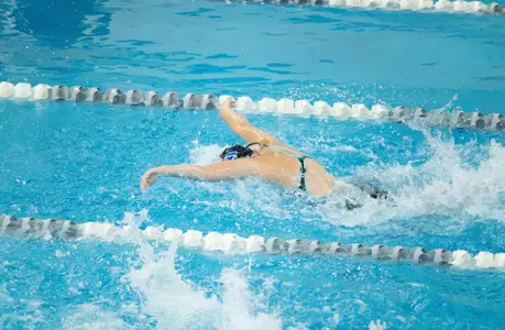 Female army swimmer swims the butterfly in the pool during a meet