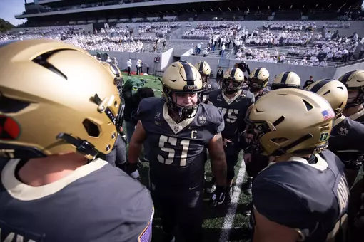 Brady Small leads a huddle of Army football players before the team's win over Tulane on October 10.