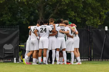 Army men's soccer team huddles before a match against Yale at Malek Stadium
