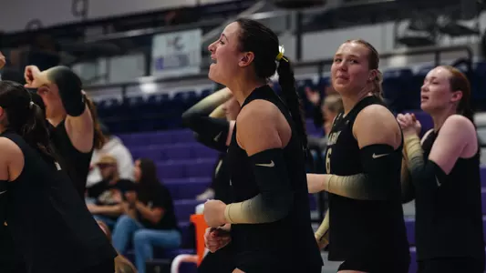 Allyson Orth Celebrates a Kill with the bench at Holy Cross