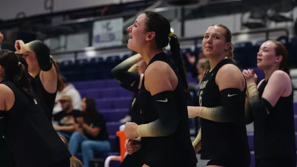 Allyson Orth Celebrates a Kill with the bench at Holy Cross