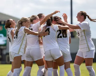 Women's Soccer celebrates after scoring a goal