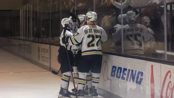 Cade De St. Hubert (27) and Vincent Salice (8) celebrate Adam Marshall's (29) first period goal against the USNTDP on Oct. 24, 2026 at Tate Rink