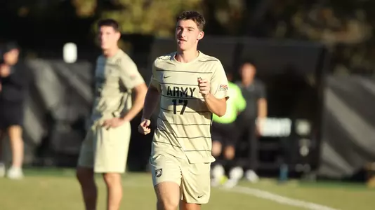 army men's soccer player runs on the field during a match against Bucknell