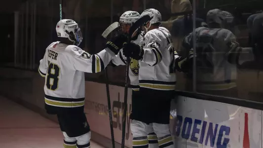 Brent Keefer (28), Barron Woodring (25) and Rhys Wallin (12) celebrate Wallin's first collegiate goal against Union at Tate Rink on Oct. 3, 2026